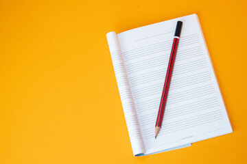 music notebook and pencil with empty background