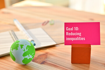There is card with the statement Goal 10:Reducing inequalities on it one of the goals of the SDGs...
