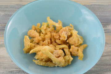 White cheddar cauliflower snack bites in blue bowl on table