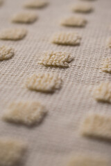 Close up of some yellow woven squares with wool texture 
