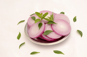 closeup sliced onion in the plate isolated on white background.