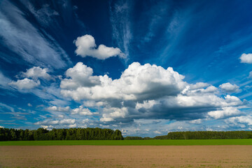 amazing cirrus and cumulus white clouds over bright blue sky, vibrant colors idyllic outdoor summer landscape, wide angle shot