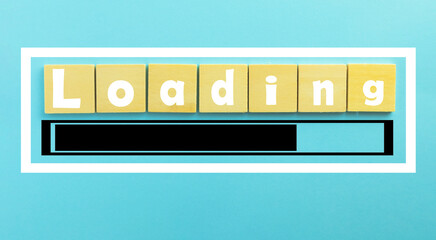 Top view Loading bar on wooden cube over blue sky pastel background.