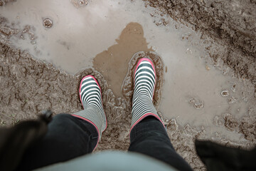 Close-up of rubber boots in a swamp top view.