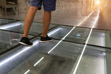 Walk on the glass floor with  clear glass to see through the electric wire,cable and pipe line are...