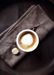 Coffee with milk on dark background. Top view. 