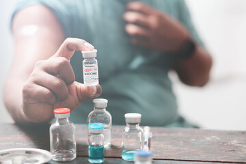 black man wearing protective mask Show plaster on the shoulder After vaccination against covid-19, health care guidelines , health protection, the impact of vaccines