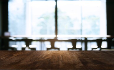 Empty wooden table in front of abstract blurred background of coffee shop . can be used for display Mock up  of product