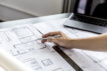 Architect engineers are writing house plans in order to modify some of the designs according to the needs of the customers after the proposals are requested to modify the drawings. Interior Design.