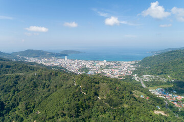 Fototapeta na wymiar Aerial view blue ocean and blue sky with mountain in the foreground at Patong Bay of Phuket Thailand Landscape of patong city phuket in sunny summer day time Beautiful tropical sea High angle view