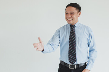 Portrait of smiling sales man wearing blue shirt and tie extending hand for hand shake to empty space