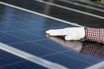Close up engineer hand touch the solar cell panels. Technician checking and install the Energy solar cell