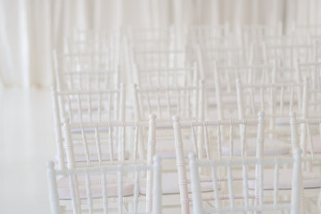 Fototapeta na wymiar White chairs at a wedding ceremony.