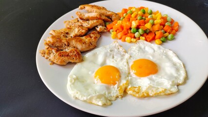 Steak chicken and eggs with vegetables, concept healthy food on a white plate.