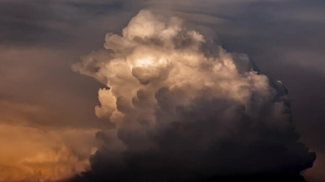 Orange clouds condense into rain clouds, sunlight reflects clouds in orange, clouds resemble human brains.