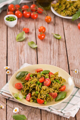 Fusilli pasta with cherry tomatoes and peas.