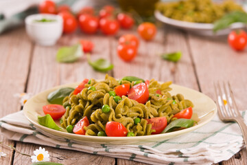 Fusilli pasta with cherry tomatoes and peas.