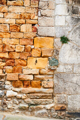 Detail of the ancient stone and bricks wall
