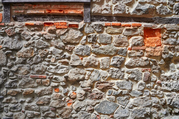 Detail of the ancient stone and bricks wall