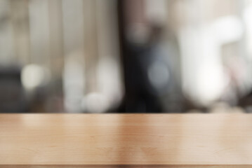 Fototapeta premium Empty wooden table top with lights bokeh on blur restaurant background.
