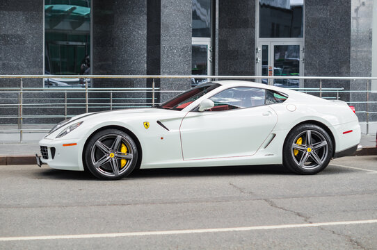 FERRARI 599 GTO standing next to building with granite facade