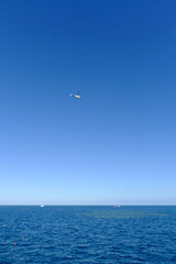 Naklejka na ściany i meble helicopter flying over the sea