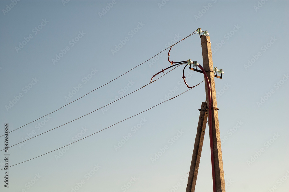 Wall mural old wooden electricity pylon view against the sky