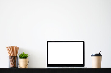 Laptop computer with blank screen in office