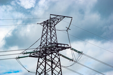 High voltage power line tower on the background of the sky