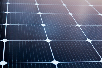 Solar panel close-up with the rays of the setting sun in the corner.