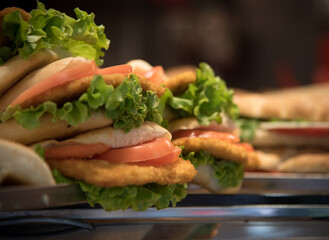 Fresh delicious and tasty burger snack on a slice of homemade bread with healhty  vegetables.