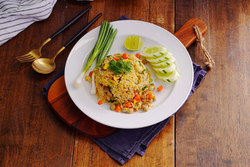 Homemade pork fried rice with carrots, green peas, garlic, onions and cilantro, served on the table