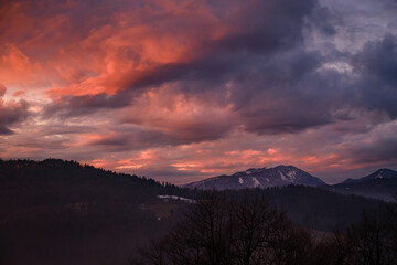 Fototapeta na wymiar Dramatic orange sunset above Blegos hill in Slovenia