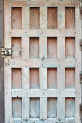 Vertical photograph of a lone vintage wood door