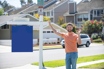 Smiling real estate agent near new residence to sale, outside. Rent new home. Copy space.