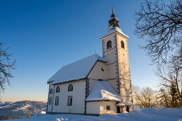 Fototapeta na wymiar Gora or Malenski vrh mountain with church in Slovenia in winter