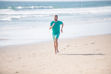 Man running. Male runner athlete run on sandy beach.