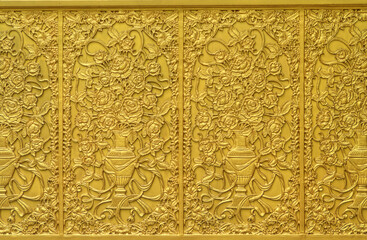 Fototapeta na wymiar Image of golden flowers with flowerpots on metallic wall. It constructed with metal and painted gold color.