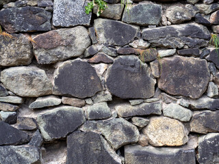 Texture rubble masonry made of uneven stone bricks. Background of the wall of the historical castle...