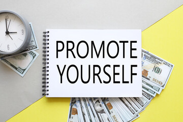 promote yourself. background with money, dollar bills and yellow background. text on notepad