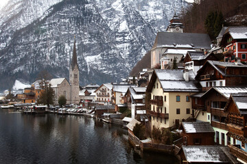 Fototapeta premium Hallstatt, Austria Dec 26,2017:scen of church and Hallstatt city in winter times cover with snow