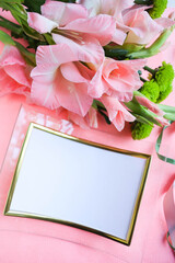 mockup greeting card. bouquet of pink gladioli on pink background and space for text 