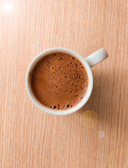 cup of coffee on wooden table