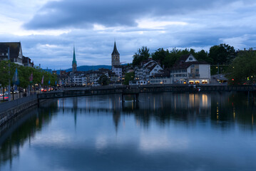 Old town of Zurich with river Limmat and churches St. Peter and Fraumünster (Women's minster) at Saturday night at summertime. Photo taken June 5th, 2021, Zurich, Switzerland.