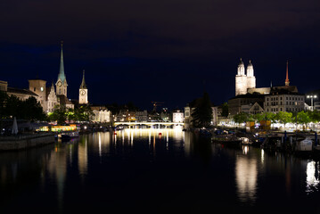 Fototapeta na wymiar Old town of Zurich with river Limmat and churches St. Peter, Great Minster and Women's Minster at night at summertime. Photo taken June 5th, 2021, Zurich, Switzerland.