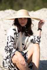 Young woman in summer hat on the beach