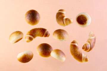 Flying buns on a powder-colored background.