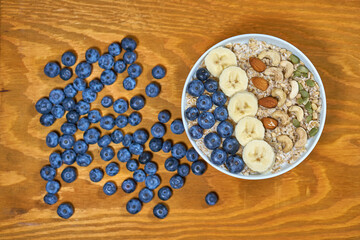 Oatmeal and blueberries. Oatmeal, bananas, nuts, cashews, almonds, hazelnuts. Health food. Correct breakfast. High quality photo