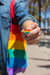 Man with rainbow reusable bag and lgbt badge, pride month