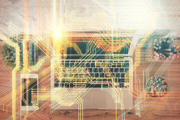 Double exposure of map hologram drawing over study table background with computer. Concept of international network. Top view.